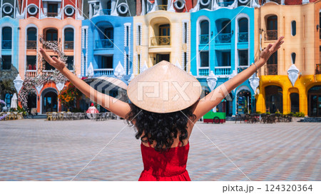 young woman tourist traveler in Vietnamese hat Non La on Vinpearl Island at VinWonders Amusement Park in Nha Trang at summer vacation in Asia. Travel and tourism in Vietnam 124320364