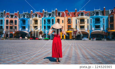 female tourist traveler in Vietnamese hat Non La takes in sights on Vinpearl Island at VinWonders Amusement Park in Nha Trang at summer vacation in Asia. Travel and tourism in Vietnam female tourist traveler in Vietnamese hat Non La takes in sights on Vinpearl Island at VinWonders Amusement Park in Nha Trang at summer vacation in Asia. Travel and tourism in Vietnam 124320365