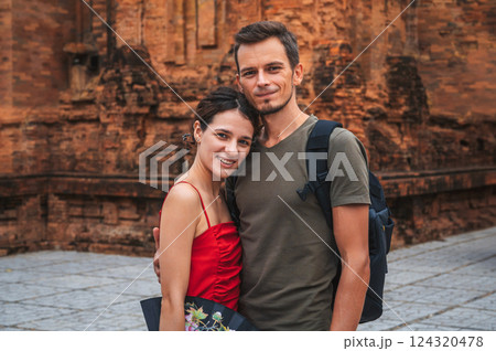 happy adult couple of tourists in love at the ancient famous landmark of Cham Towers of Po Nagar in Nha Trang in Vietnam in Asia happy adult couple of tourists in love at the ancient famous landmark of Cham Towers of Po Nagar in Nha Trang in Vietnam in Asia 124320478