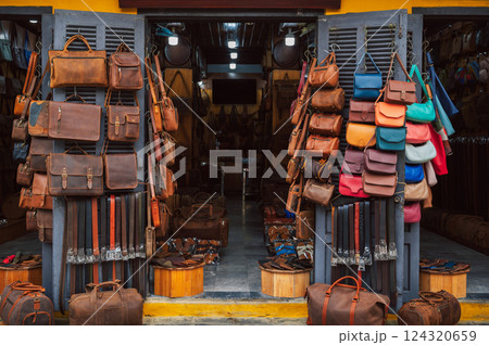 handmade leather bags, belts and accessories on counter in a shop at street market in Hoi An in Vietnam in Asia 124320659