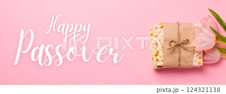 Passover, matzah with flowers, with greeting text, on a pink background Passover, matzah with flowers, with greeting text, on a pink background 124321138