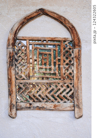 old antique Uzbek wooden window with traditional carved pattern old antique Uzbek wooden window with traditional carved pattern 124322605