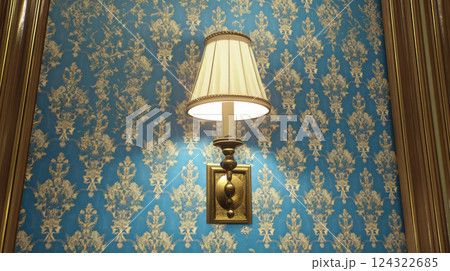 Elegant wall lamp on ornate blue wallpaper 124322685