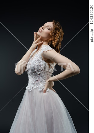 Stunning bride in elegant gown posing gracefully for a dreamy look Stunning bride in elegant gown posing gracefully for a dreamy look 124323126