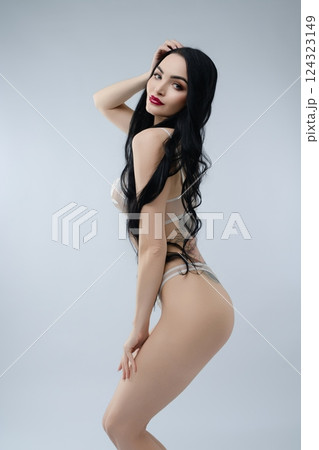 Elegant bride in delicate lingerie poses like a princess for a stunning portrait 124323149