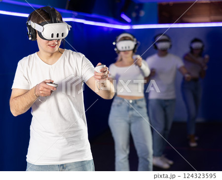 guy in virtual reality helmet playing active video games 124323595