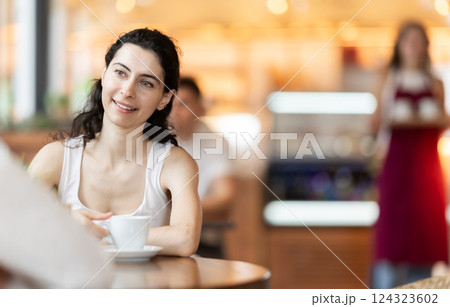 Two women chatting in a cafe 124323602