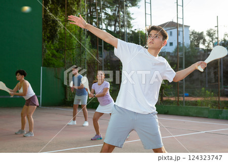 Young man playing Basque pelota on outdoor pelota court Young man playing Basque pelota on outdoor pelota court 124323747