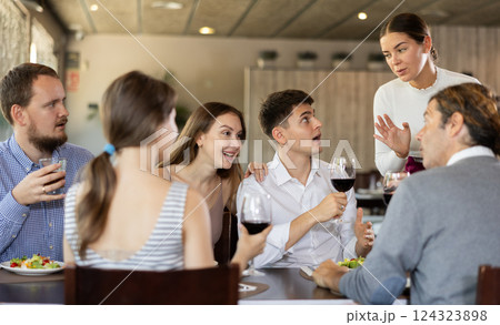 Female waitress taking order from group of friends in restaurant 124323898