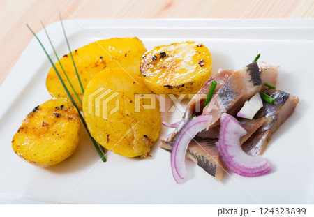 Pickled herring with pieces of potatoes Pickled herring with pieces of potatoes 124323899