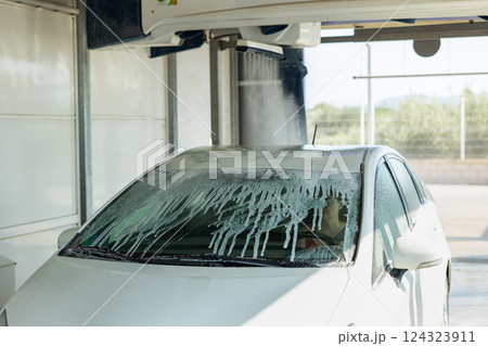 Process of car washing with driver inside Process of car washing with driver inside 124323911
