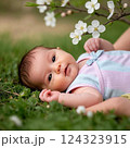 花の咲く芝生に寝転ぶ女の子のハーフの赤ちゃん 124323915