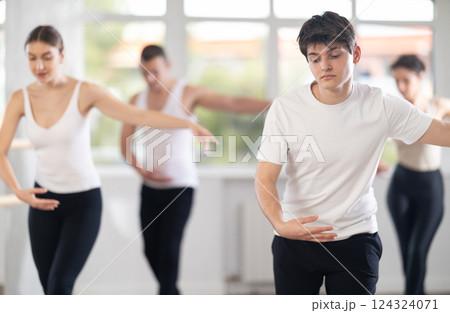 Young guy participating in group ballet class in choreography studio 124324071