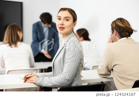 Young smiling woman attending lecture in university 124324187
