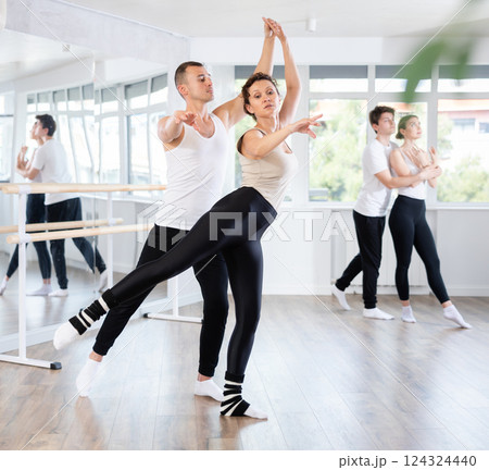 Young man and adult woman rehearsing pair ballet 124324440