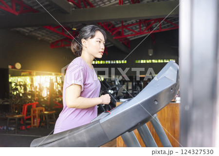 Chinese east asian women training on treadmill machine at the gym. Fitness exercise and healthy lifestyle concept Chinese east asian women training on treadmill machine at the gym. Fitness exercise and healthy lifestyle concept 124327530