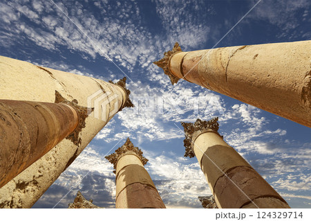 Roman Columns in the Jordanian city of Jerash (Gerasa of Antiquity), capital and largest city of Jerash Governorate, Jordan. Against the background of a beautiful sky with clouds Roman Columns in the Jordanian city of Jerash (Gerasa of Antiquity), capital and largest city of Jerash Governorate, Jordan. Against the background of a beautiful sky with clouds 124329714
