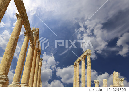 Roman Columns in the Jordanian city of Jerash (Gerasa of Antiquity), capital and largest city of Jerash Governorate, Jordan. Against the background of a beautiful sky with clouds Roman Columns in the Jordanian city of Jerash (Gerasa of Antiquity), capital and largest city of Jerash Governorate, Jordan. Against the background of a beautiful sky with clouds 124329796
