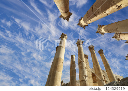 Roman Columns in the Jordanian city of Jerash (Gerasa of Antiquity), capital and largest city of Jerash Governorate, Jordan. Against the background of a beautiful sky with clouds Roman Columns in the Jordanian city of Jerash (Gerasa of Antiquity), capital and largest city of Jerash Governorate, Jordan. Against the background of a beautiful sky with clouds 124329919