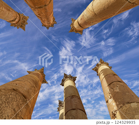 Roman Columns in the Jordanian city of Jerash (Gerasa of Antiquity), capital and largest city of Jerash Governorate, Jordan. Against the background of a beautiful sky with clouds Roman Columns in the Jordanian city of Jerash (Gerasa of Antiquity), capital and largest city of Jerash Governorate, Jordan. Against the background of a beautiful sky with clouds 124329935