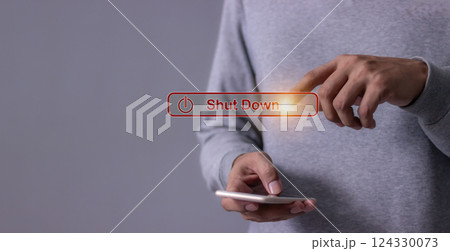 Young man with smartphone hand touching Shut Down button press power OFF Young man with smartphone hand touching Shut Down button press power OFF 124330073