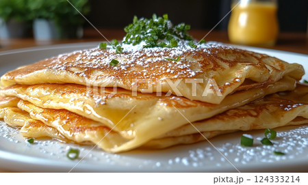 Stack of french toast crepes topped with fresh strawberries, maple syrup and powdered sugar Stack of french toast crepes topped with fresh strawberries, maple syrup and powdered sugar 124333214