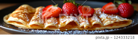 Stack of french toast crepes topped with fresh strawberries, maple syrup and powdered sugar Stack of french toast crepes topped with fresh strawberries, maple syrup and powdered sugar 124333218