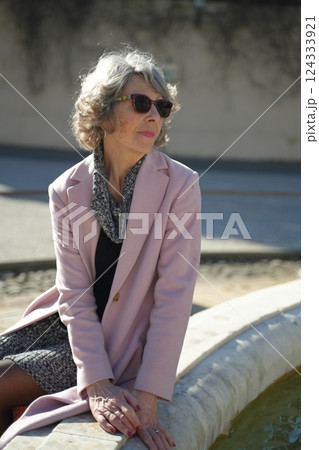 Elderly Woman in Sunglasses Relaxing Outdoors 124333921