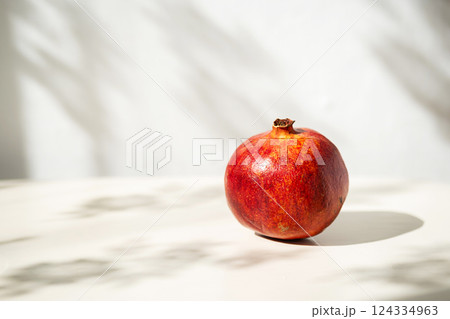 Single Pomegranate in Soft Natural Light with Interesting Shadows. Single Pomegranate in Soft Natural Light with Interesting Shadows. 124334963