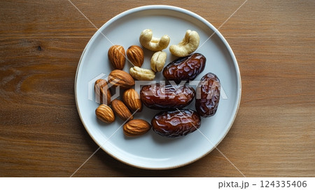 Ascension of Bahau'llah Plate of dates, almonds, and cashews on wooden table Ascension of Bahau'llah Plate of dates, almonds, and cashews on wooden table 124335406