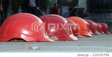 Kiev, Ukraine September 26, 2020: Workers' helmets lined up in a square in protest Kiev, Ukraine September 26, 2020: Workers' helmets lined up in a square in protest 124335740