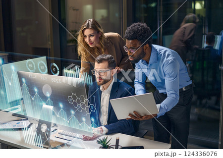 Diverse Team Collaborating on Business Analytics with Digital Visualization in Modern Office Diverse Team Collaborating on Business Analytics with Digital Visualization in Modern Office 124336076