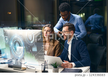 Team of Professionals Working on Futuristic Data Analysis in Modern Office Environment 124336083