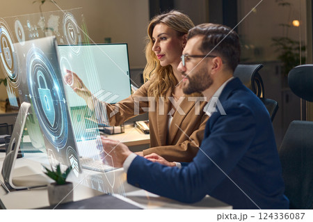 Technology Professionals Analyzing Cybersecurity Data on a Futuristic Digital Interface Screen Technology Professionals Analyzing Cybersecurity Data on a Futuristic Digital Interface Screen 124336087