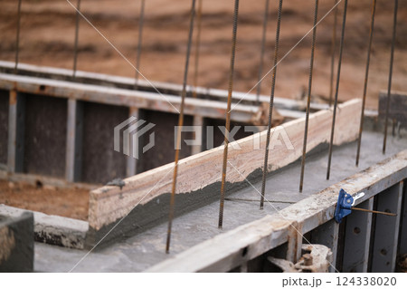 Construction of pile-grillage foundation. Monolithic foundation with metal reinforcement. Monolithic concrete foundation. House construction Construction of pile-grillage foundation. Monolithic foundation with metal reinforcement. Monolithic concrete foundation. House construction 124338020