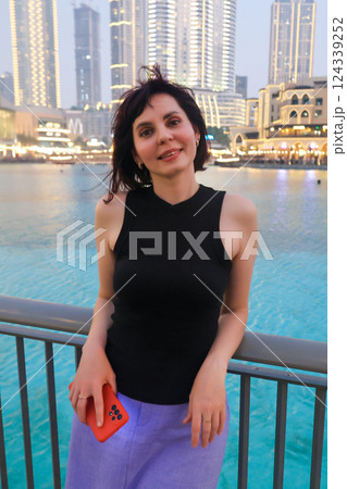 Evening portrait of a woman 40-44 years old against the backdrop of city lights 124339252