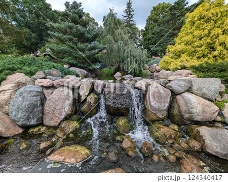 Tranquil Waterfall at Minnesota Landscape Arboretum Surrounded by Lush Greenery Tranquil Waterfall at Minnesota Landscape Arboretum Surrounded by Lush Greenery 124340417