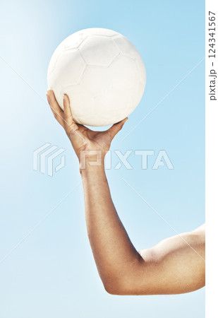Arm, hand and holding soccer ball, sports and fitness, muscle and strong, athlete training outdoor with blue sky. Sport motivation, soccer and closeup, exercise and workout for healthy active living. 124341567