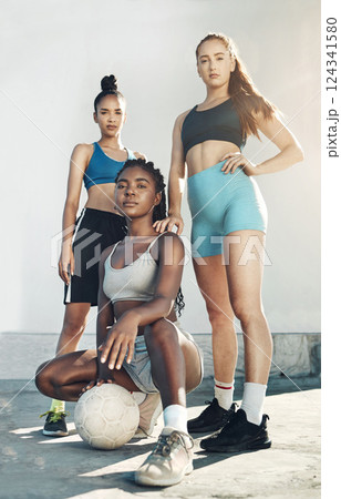 Team sports, football and portrait of friends standing together with ball on city court outdoors. Woman diversity, sport fitness health and girlfriends empowerment or support before competition match Team sports, football and portrait of friends standing together with ball on city court outdoors. Woman diversity, sport fitness health and girlfriends empowerment or support before competition match 124341580