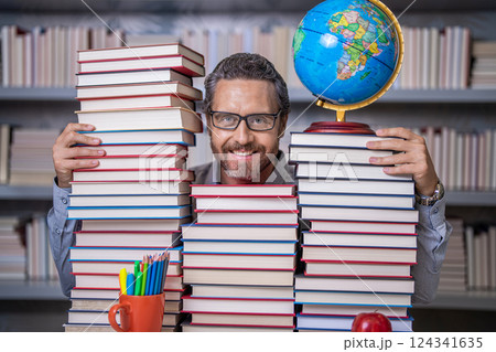 education in school library. man bookworm get knowledge. teachers and knowledge day. clever school teacher. bookworm man in classroom. school teacher with book literature. Unleash your inner genius 124341635