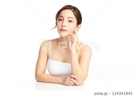 A beautiful young Asian woman with clean, fresh skin against a white background. Skincare, facial treatment, cosmetology, beauty, and spa. An elegant portrait of an Asian woman. A beautiful young Asian woman with clean, fresh skin against a white background. Skincare, facial treatment, cosmetology, beauty, and spa. An elegant portrait of an Asian woman. 124341945