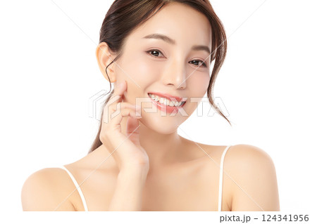A beautiful young Asian woman with clean, fresh skin against a white background. Skincare, facial treatment, cosmetology, beauty, and spa. An elegant portrait of an Asian woman. 124341956