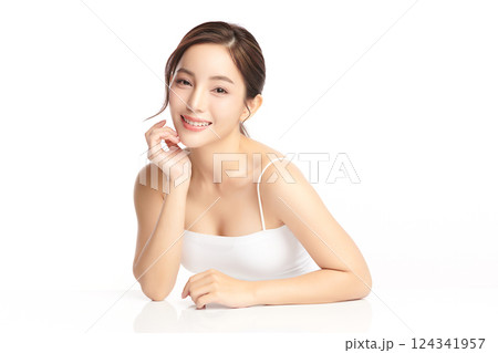 A beautiful young Asian woman with clean, fresh skin against a white background. Skincare, facial treatment, cosmetology, beauty, and spa. An elegant portrait of an Asian woman. 124341957
