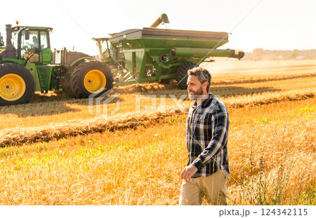 Crop harvest and farming. Farmer in field. Hispanic man farmer check agriculture field harvest. Man agronomist farmer. Crop protection. Agriculture farm. Farm man at wheat field. Banner Crop harvest and farming. Farmer in field. Hispanic man farmer check agriculture field harvest. Man agronomist farmer. Crop protection. Agriculture farm. Farm man at wheat field. Banner 124342115