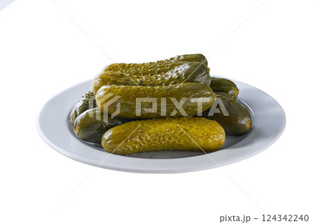 pickled cucumbers on a white plate isolated on a white background. pickled cucumbers on a white plate isolated on a white background. 124342240