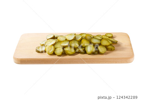 chopped pickled cucumbers on a cutting board isolated on a white background. chopped pickled cucumbers on a cutting board isolated on a white background. 124342289