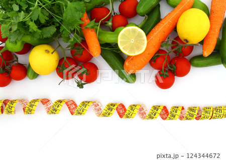 diet concept with measuring tape . fresh vegetables on a white background. Selective focus. diet concept with measuring tape . fresh vegetables on a white background. Selective focus. 124344672