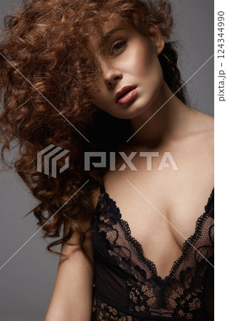 beautiful young woman with curly hair. pretty sexual girl in underwear 124344990