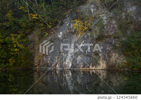 Autumn forest lake in Poland. Autumn lake in autumn forest. The autumn foliage of the trees is reflected in the lake water Autumn forest lake in Poland. Autumn lake in autumn forest. The autumn foliage of the trees is reflected in the lake water 124345660
