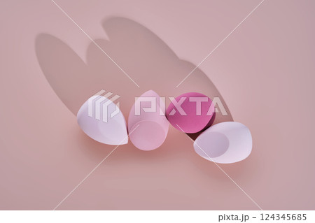 A set of makeup sponges on a pink background. A set of makeup sponges on a pink background. 124345685